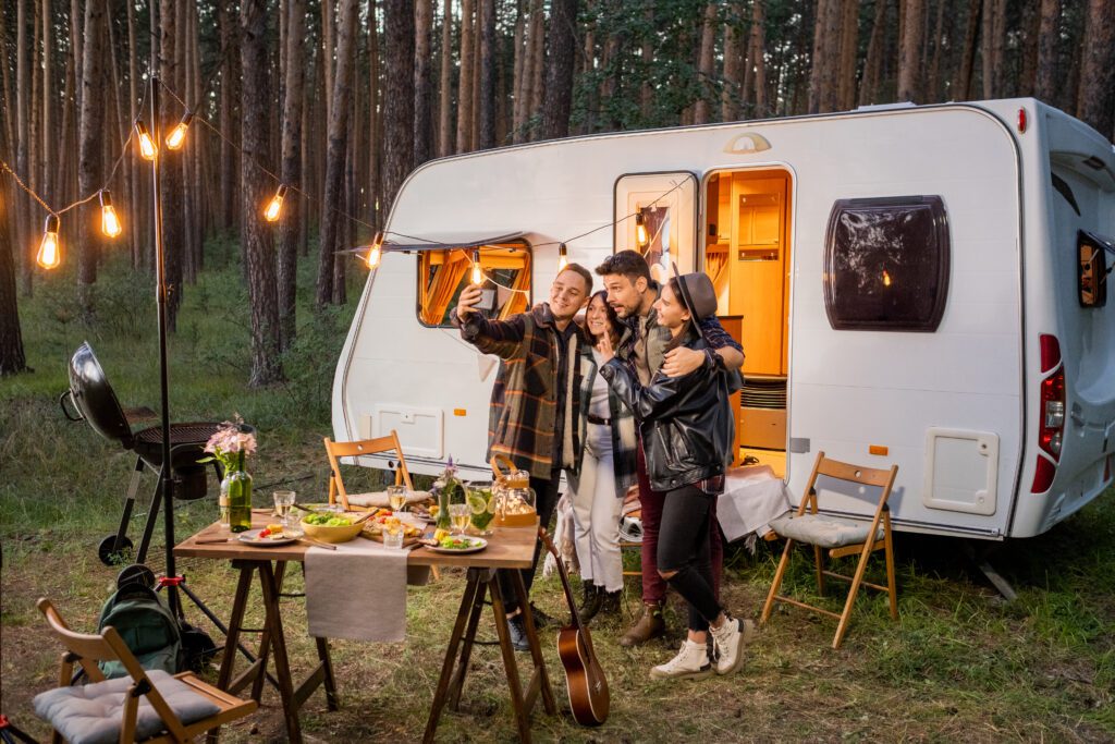 Friendly company looking in smartphone camera while making seflie