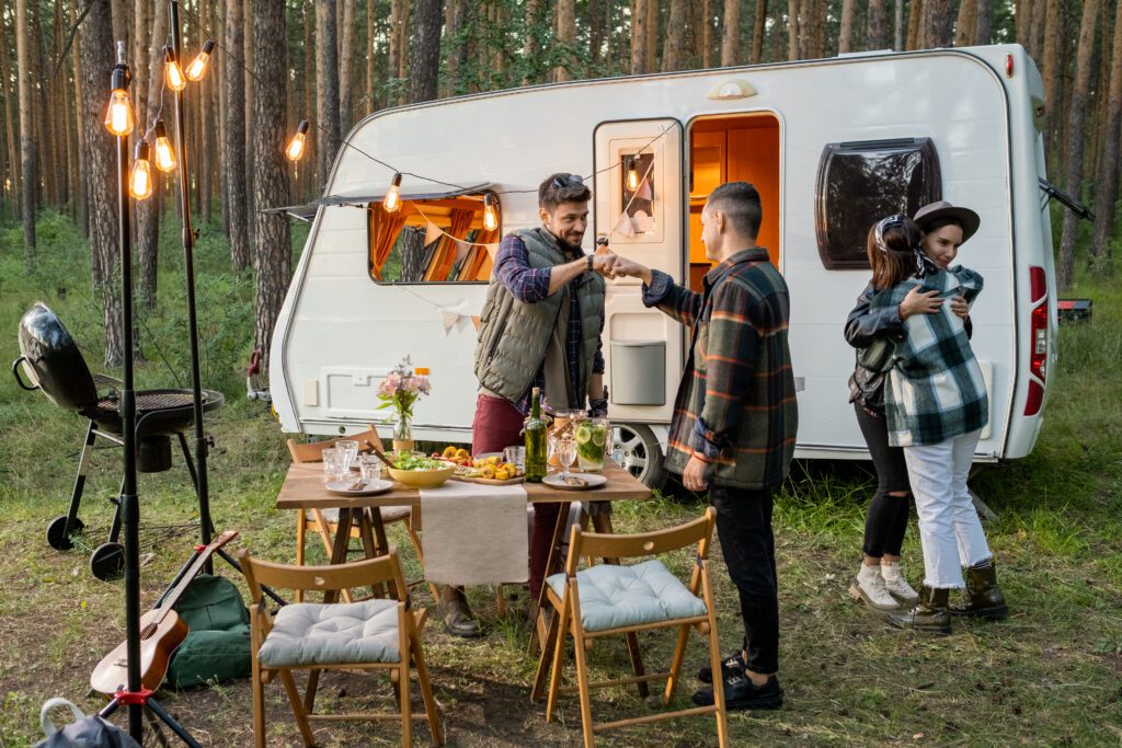 Two guys punch bumping while their girlfriends embracing